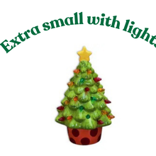 Load image into Gallery viewer, A decorated Christmas tree with lights and take-home craft kits sign text placed in front.