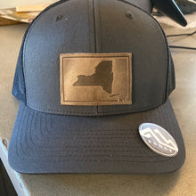 Load image into Gallery viewer, Trucker hat with leather badge with NY state by Range leather goods.   Sold At Miller&#39;s Crossing Design, Baldwinsville, NY