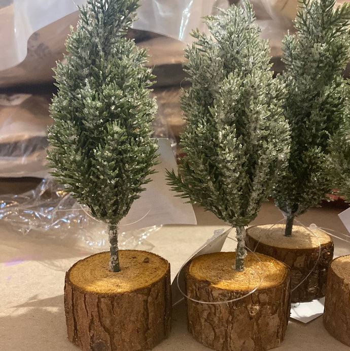 6 x 6 flocked evergreen tree in rustic wood stand. Perfect for holiday decorating.   Dimensions:2.50